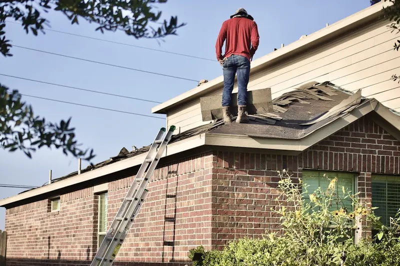 Professional roofer working on a residential roof in Piner